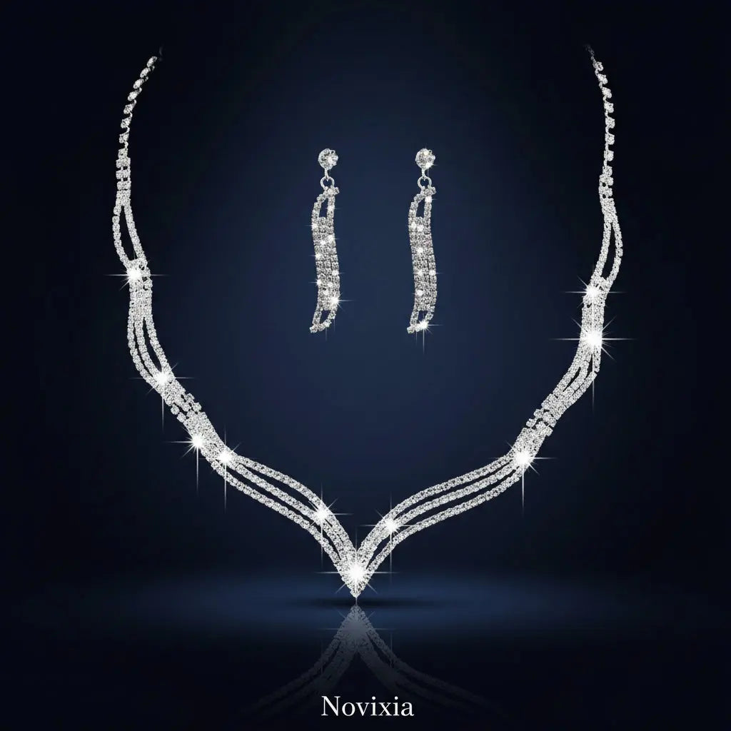 Silver necklace and earrings set on a black background