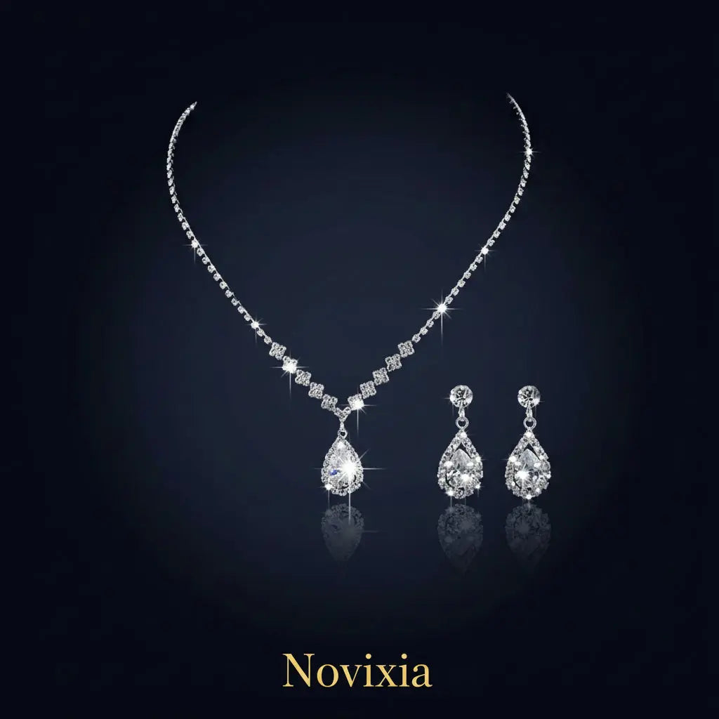 Silver necklace and earrings set on a black background