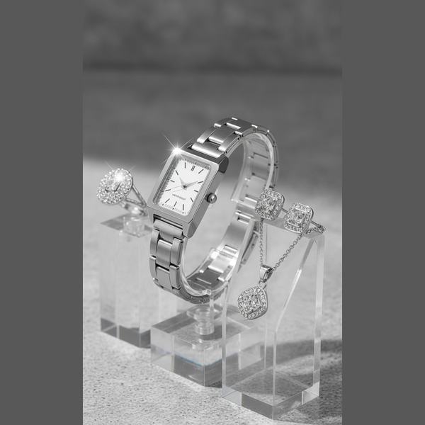 Silver watch and earrings on a clear stand with a gray background