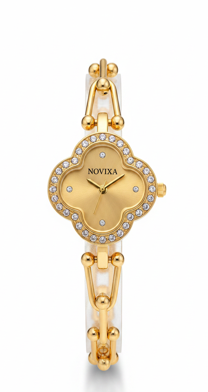 A gold-plated women's watch by Novixa with a white ceramic link band and a clover-shaped dial encrusted with small clear crystals, shown on a white background.