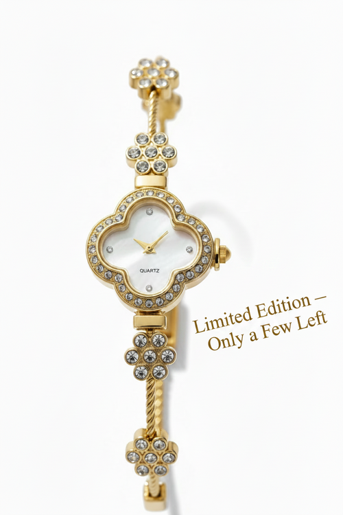 Gold-tone watch with a scalloped flower-shaped case, white dial, and crystal rhinestone accents, shown on a clean white background.