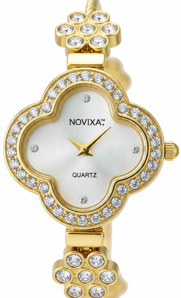 Gold-tone quartz watch with a clover-shaped dial and matching bracelet, embellished with clear rhinestones. The white mother-of-pearl dial features the brand name 'NOVIXA' and 'QUARTZ' text.